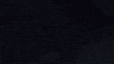 a shadow of a person is cast on a wall in a dark room