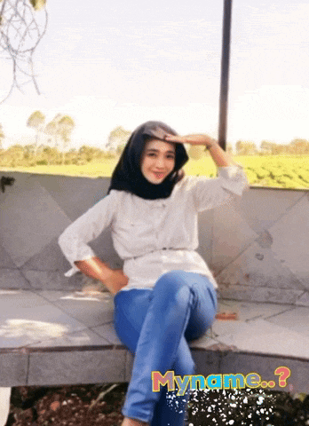 a woman in a hijab sits on a bench with myname written on the bottom of the photo