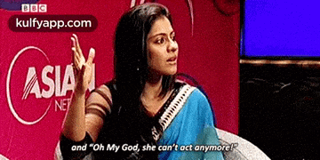 a woman is sitting in front of a screen that says asia