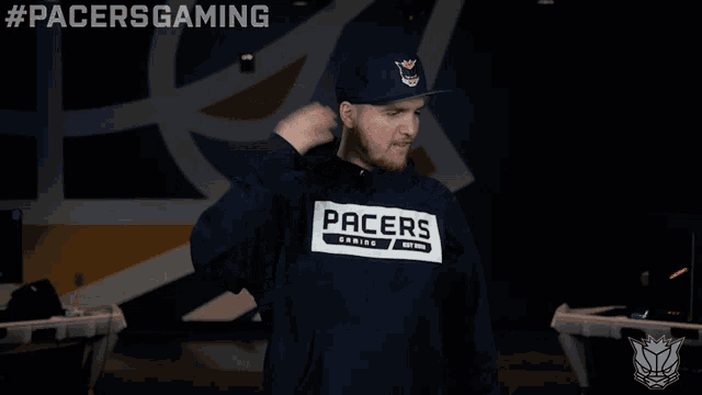 a man wearing a pacers gaming hoodie and a hat