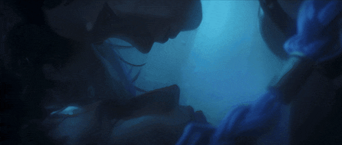 a squid is swimming in a dark blue water