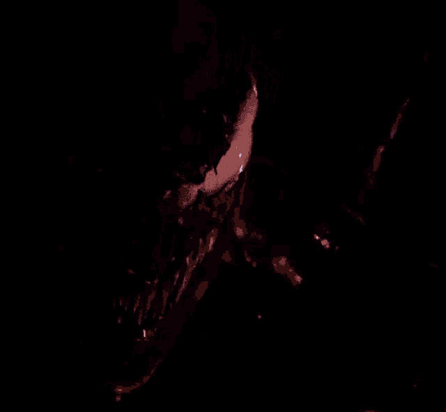 a close up of venom 's face with a purple background