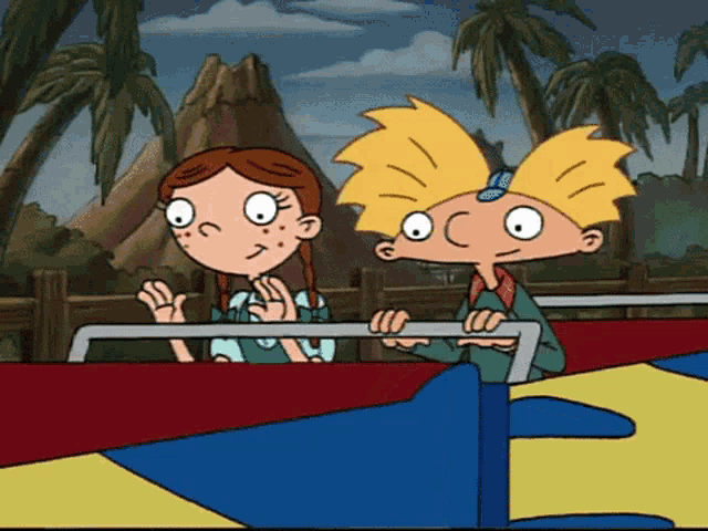 a boy and a girl are riding on a roller coaster
