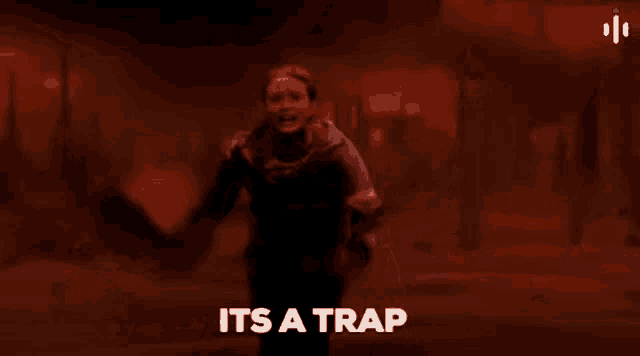 a woman is standing in front of a fire with the words `` it 's a trap '' written on the bottom .