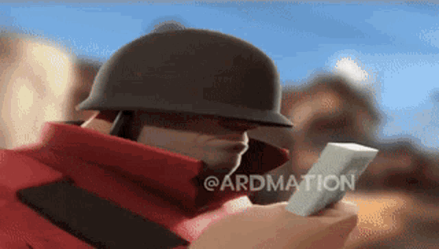 a man in a helmet is holding a piece of paper with the word ardmation written on it