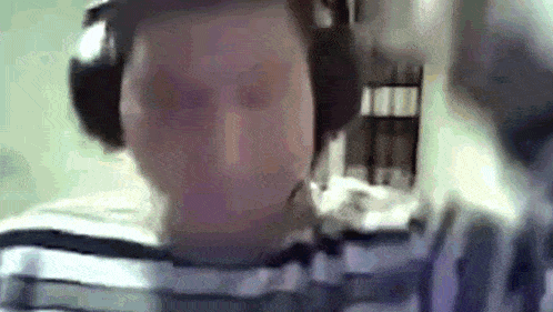 a man wearing headphones is looking at the camera