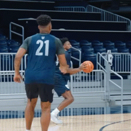 a basketball player with the number 21 on the back of his shirt