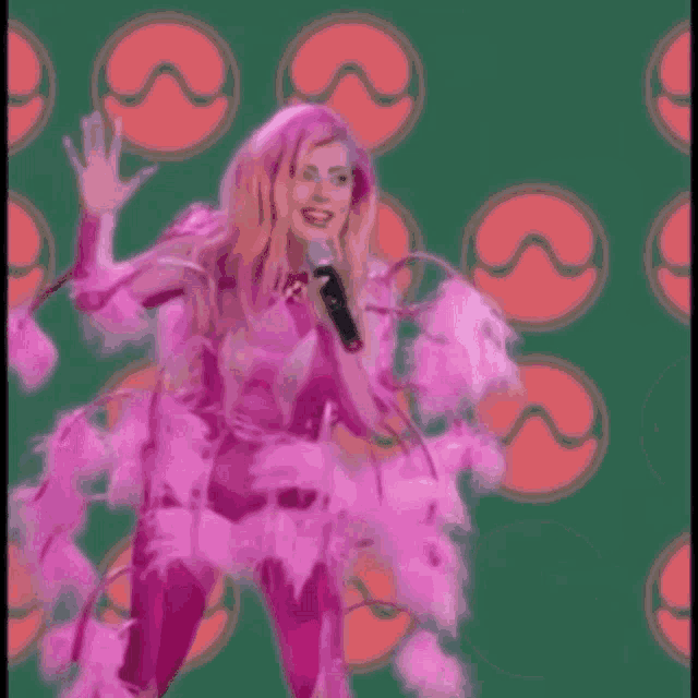 a blurry picture of a woman in a pink dress on a green background