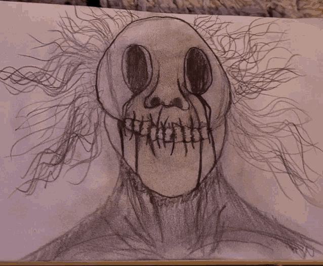 a drawing of a scary clown with blood dripping from his eyes