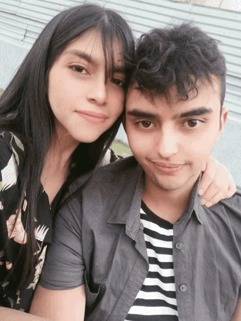 a man and a woman are posing for a picture