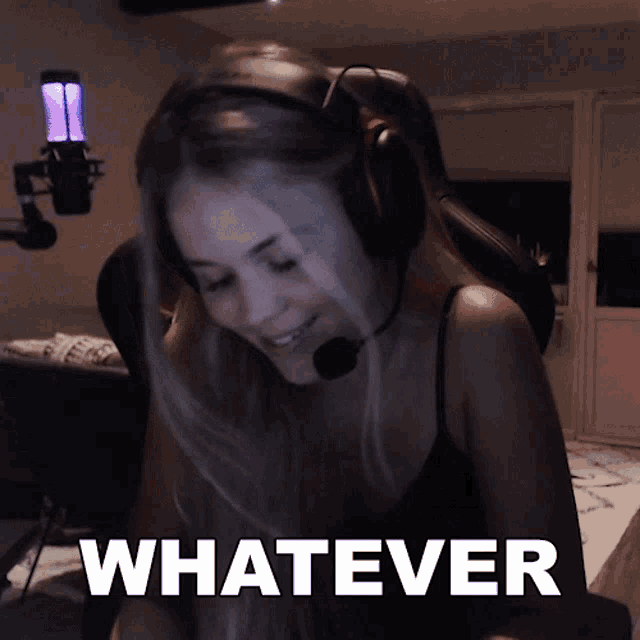 a woman wearing headphones and a microphone says " whatever " in front of her