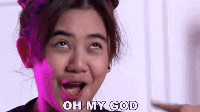 a woman is making a funny face and saying oh my god .