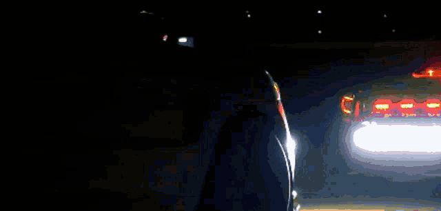 a car is driving through a dark tunnel with a bright light coming out of it