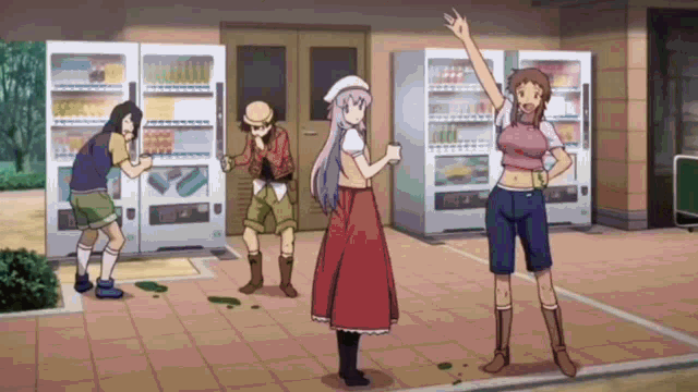 a group of people are standing in front of vending machines .