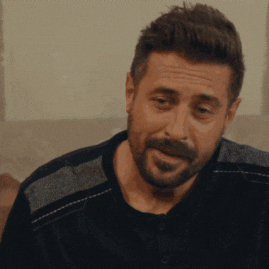 a man with a beard wearing a black sweater