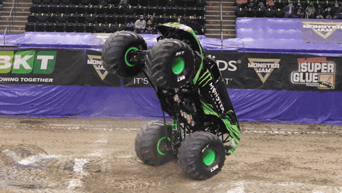 a monster jam monster truck is doing a trick