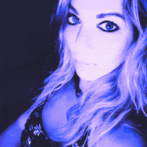 a close up of a woman 's face in a blue light