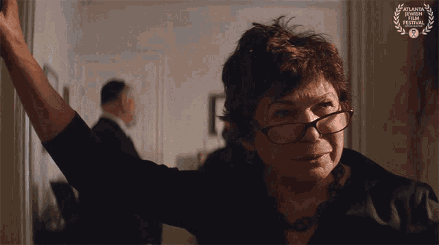 a woman wearing glasses and a laurel wreath from atlanta film festival