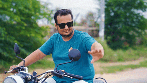 a man wearing sunglasses is sitting on a motorcycle