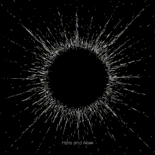 a black background with a white circle and the words here and now below it