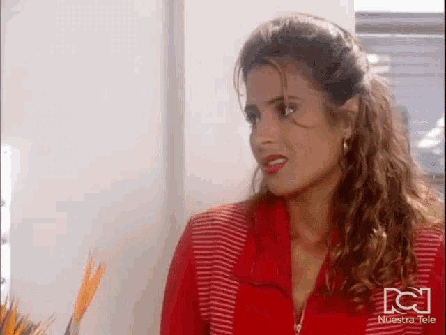 a woman in a red and white striped shirt with nuestra tele on the bottom right