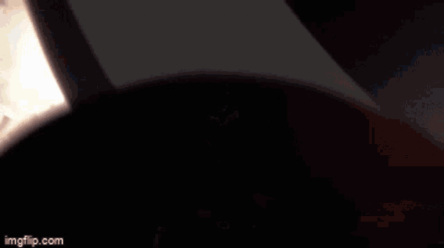 a silhouette of a man wearing a hat and holding a gun with imgflip.com written below him