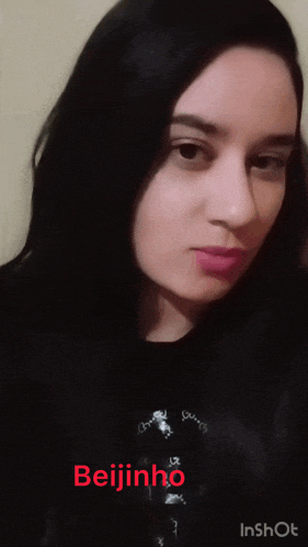 a woman is wearing a black shirt with the name beijinho on it