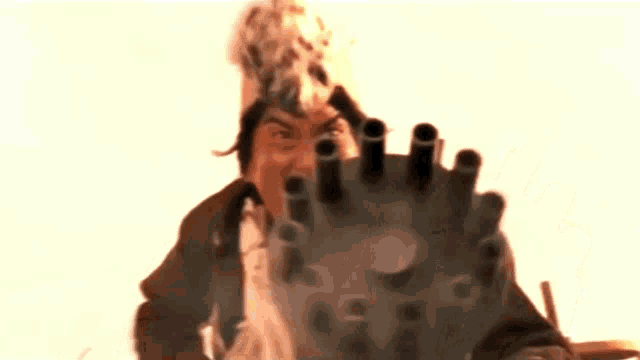 a man wearing a feathered hat is holding a cannon in his hand