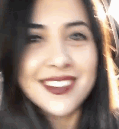 a close up of a woman 's face with a smile on it .