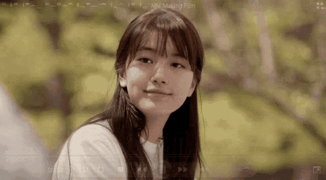 a girl is smiling in front of a screen that says ' my making film '