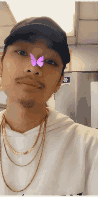 a man with a butterfly on his nose is wearing a hat