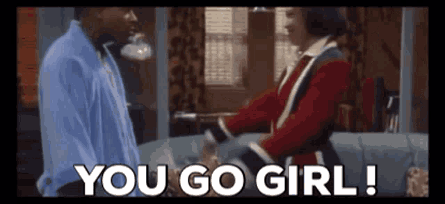 a man and a woman are standing next to each other and the woman is saying you go girl !