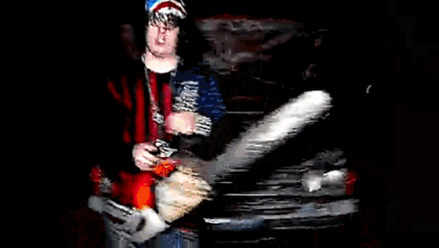 a person wearing a red and black striped shirt with a pentagram pendant