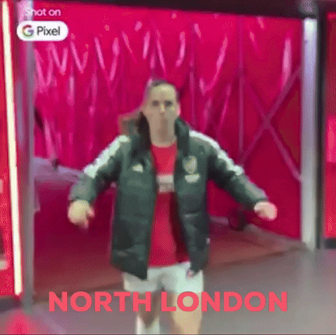 a person is dancing in front of a red wall with the words north london on it