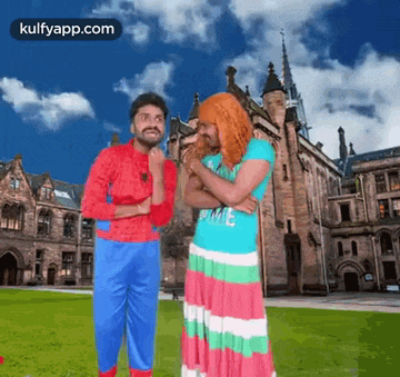 a man in a spiderman costume is standing next to a woman in a pink dress