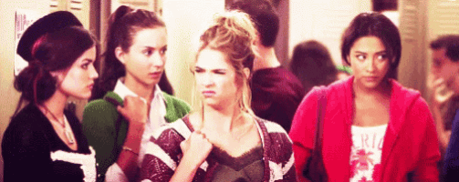 a group of girls are standing in a hallway with one wearing a shirt that says ' rio ' on it