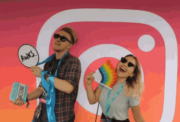a man and a woman are posing in front of an instagram logo