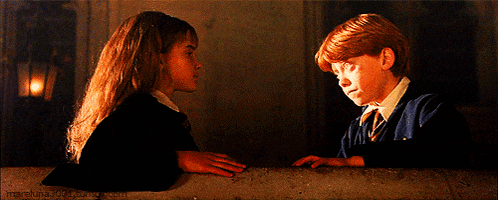 a boy and a girl are standing next to each other and the girl is wearing a headband and the boy is wearing a tie