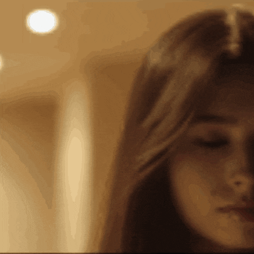 a close up of a woman 's face with a blurred background
