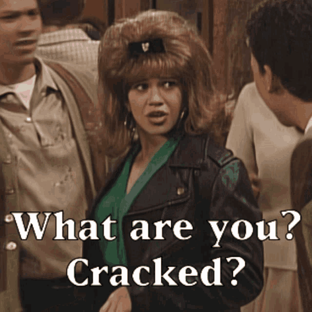a woman in a leather jacket stands in front of a group of people asking what are you cracked