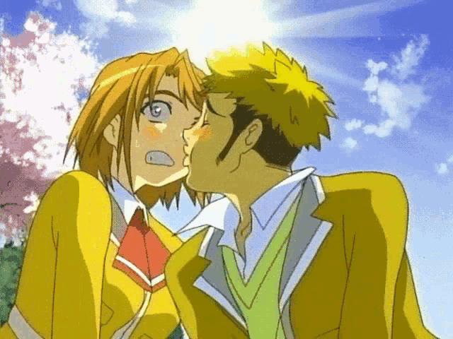 a man and a woman kissing in front of a blue sky