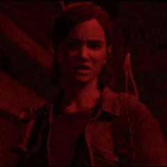 a woman is screaming in a dark room in a video game in red light .