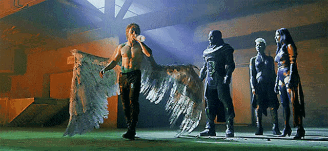 a man with wings is drinking from a bottle