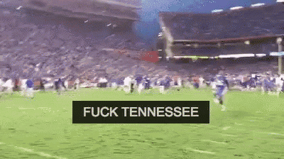 a football game is being played in a stadium with a banner that says fuck tennessee .
