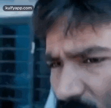 a close up of a man 's face with a beard and mustache