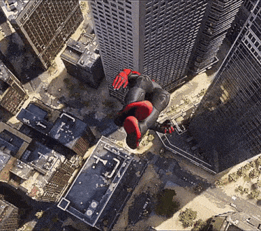 an aerial view of a city with a person in a spiderman suit flying through the air