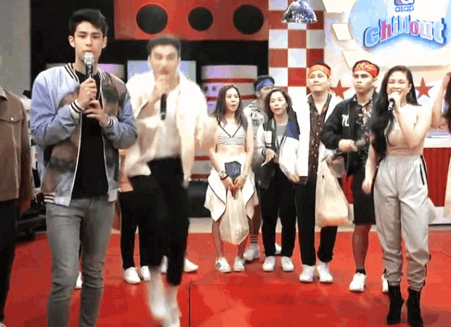 a group of people standing on a red carpet in front of a sign that says ' chillout '