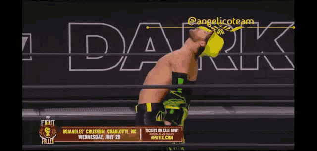 a man in a wrestling ring with the word dark on the bottom
