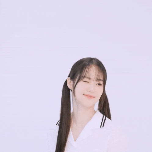 a girl with pigtails is wearing a white shirt with the word miu on it