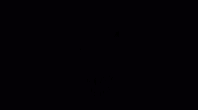 a close up of venom 's face with sharp teeth in the dark .